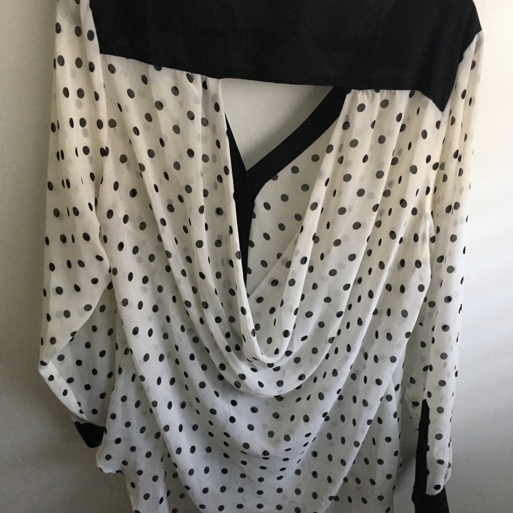 Polka dot shirt with a back cut out.
